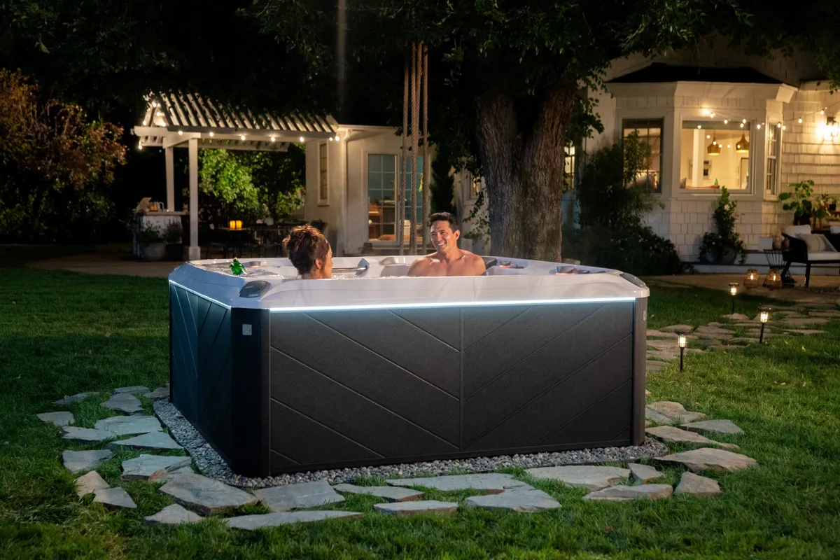 Sundance Spas Optima® hot tub in a backyard