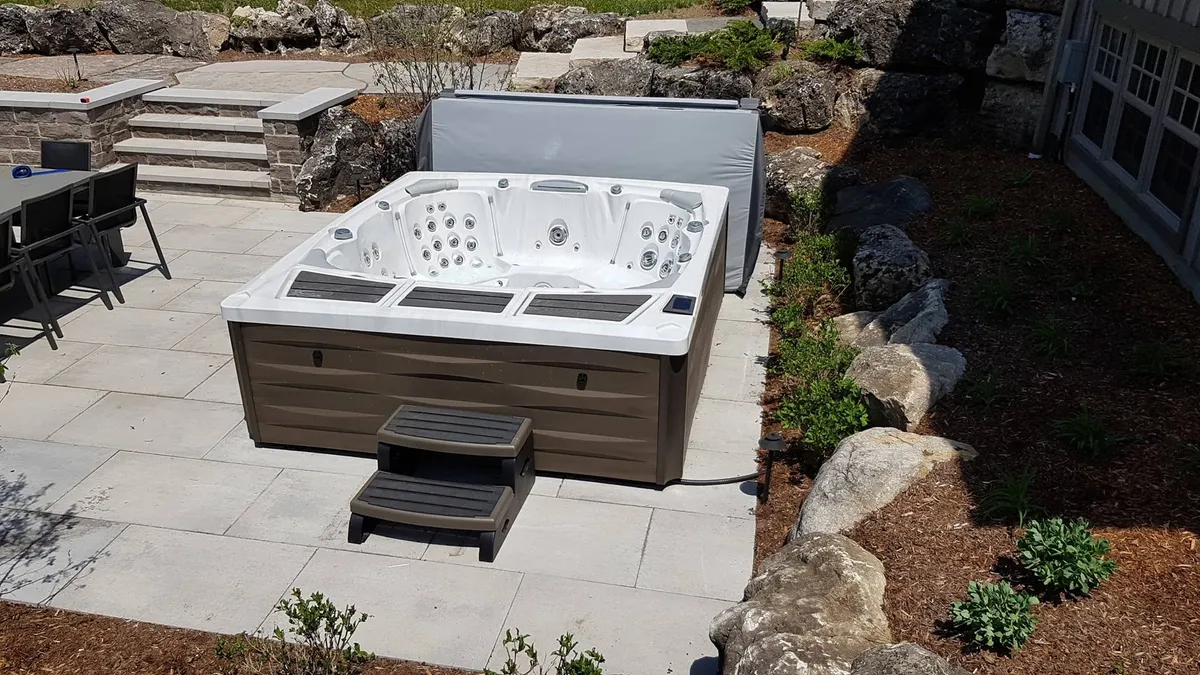 Sundance Spas Kingston™ hot tub in a backyard